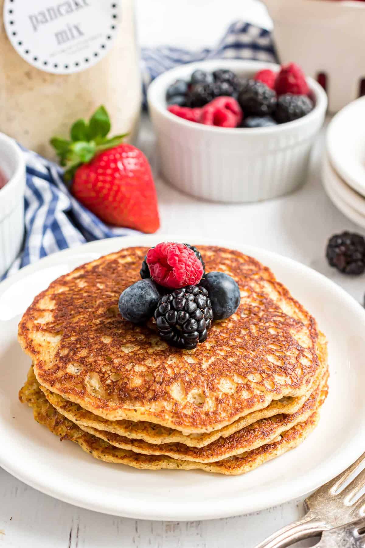 Keto pancakes with a jar of pancake mix in the background.